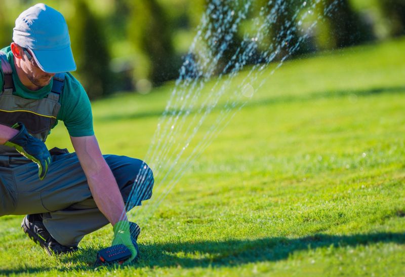 Technician inspecting sprinkler system
